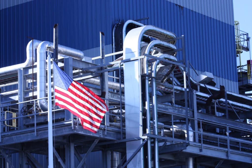 American flag hanging outside of industrial factory, Shutterstock ID#1031823571